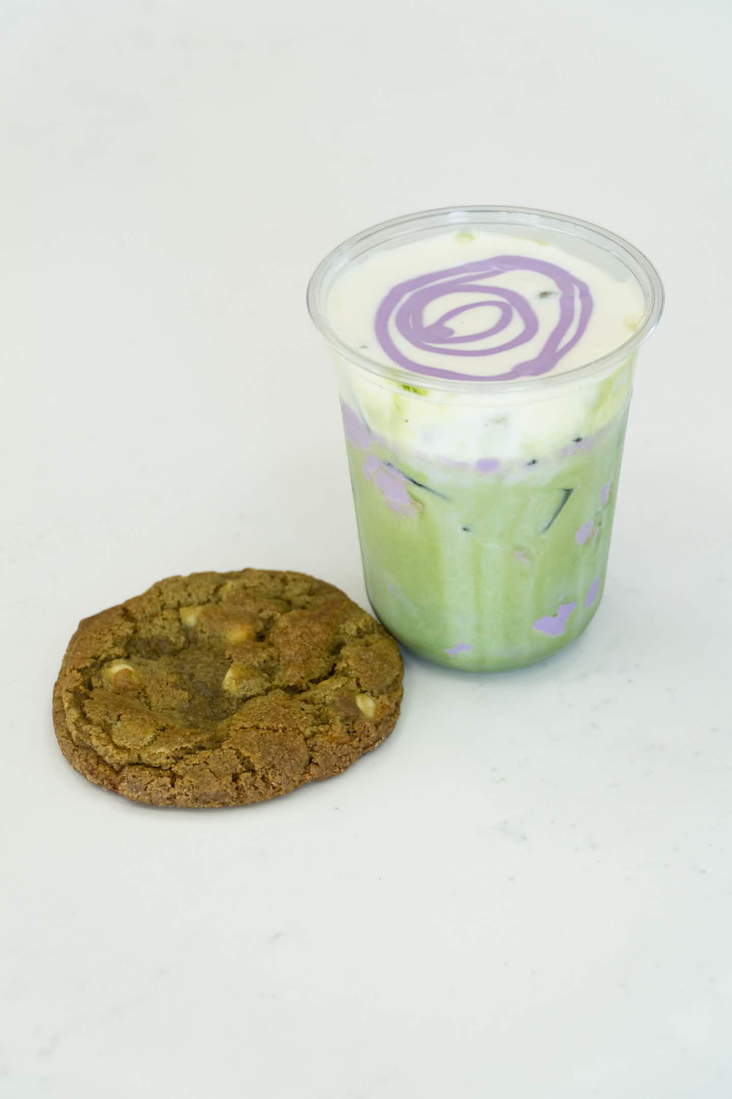 Ube matcha latte with a matcha cookie